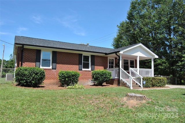 ranch-style home featuring brick siding, a porch, and a front lawn