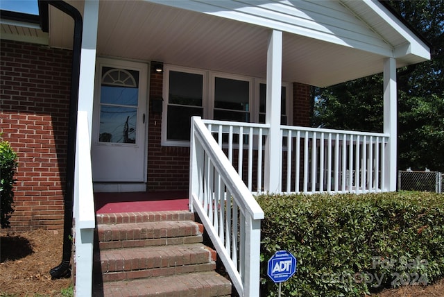 view of exterior entry featuring a porch