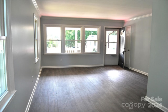 unfurnished room with dark hardwood / wood-style floors and ornamental molding