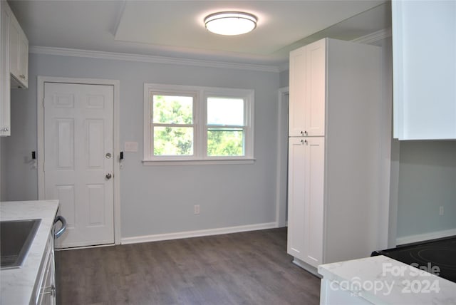 kitchen featuring dark wood-type flooring, ornamental molding, light stone countertops, and white cabinetry