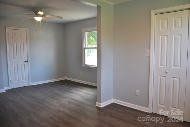 spare room featuring ceiling fan and dark hardwood / wood-style flooring