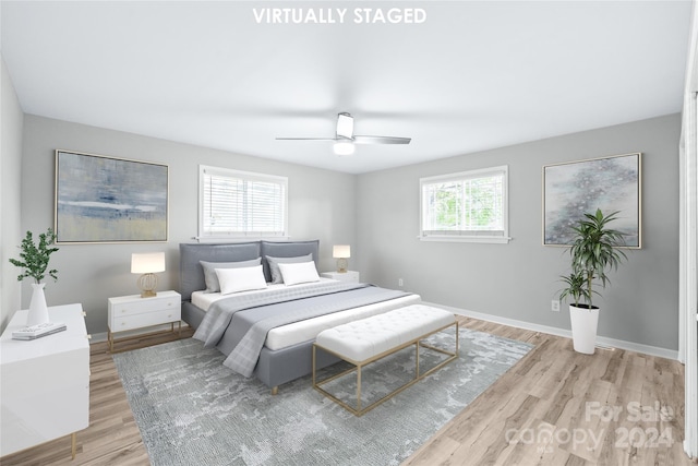 bedroom featuring ceiling fan, baseboards, and light wood-type flooring