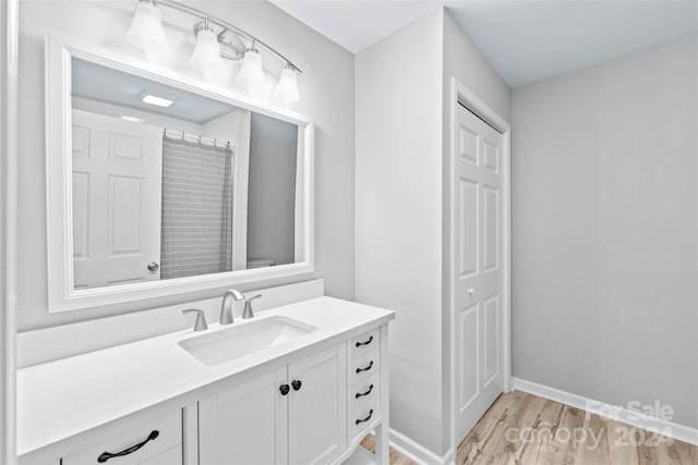 bathroom with vanity and hardwood / wood-style floors