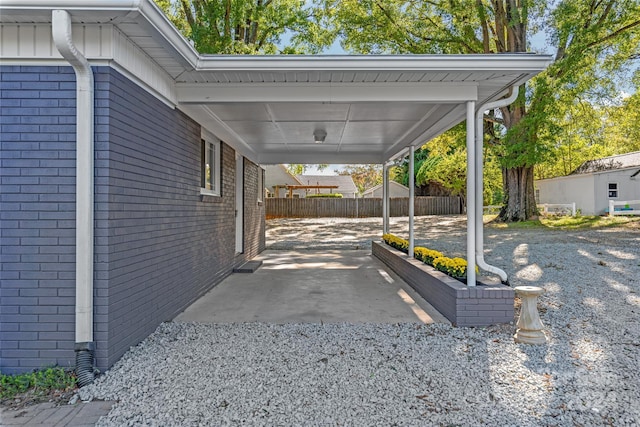 view of parking / parking lot featuring fence