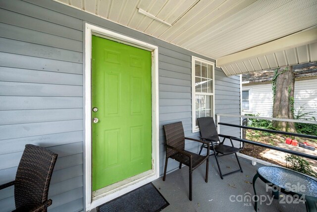 225 Flint St, Charlotte, NC 28216 - doorway to property featuring covered porch