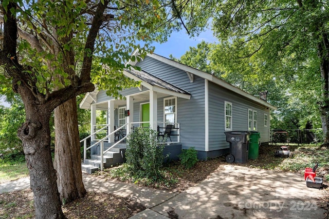 225 Flint St, Charlotte, NC 28216 - view of front of house featuring a porch, fence, and a shingled roof