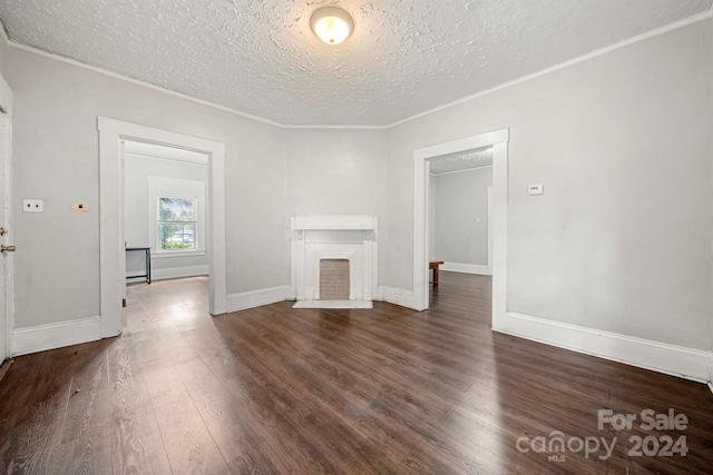 225 Flint St, Charlotte, NC 28216 - unfurnished living room with baseboards, ornamental molding, a textured ceiling, a fireplace with flush hearth, and wood finished floors