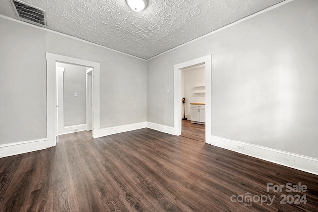 225 Flint St, Charlotte, NC 28216 - empty room with a textured ceiling, dark wood-style flooring, baseboards, and visible vents