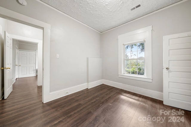 225 Flint St, Charlotte, NC 28216 - unfurnished room featuring visible vents, baseboards, ornamental molding, a textured ceiling, and dark wood finished floors
