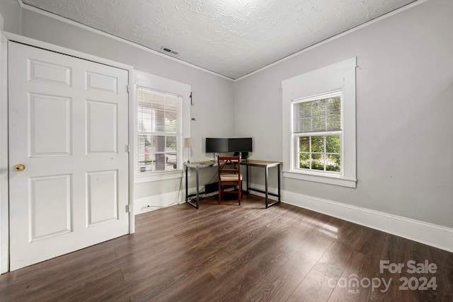 home office with a textured ceiling and dark hardwood / wood-style floors