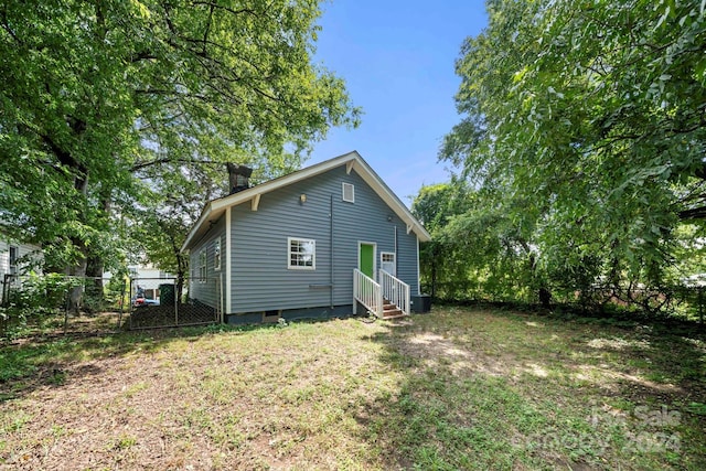 225 Flint St, Charlotte, NC 28216 - back of property with crawl space, a yard, entry steps, fence, and central AC unit