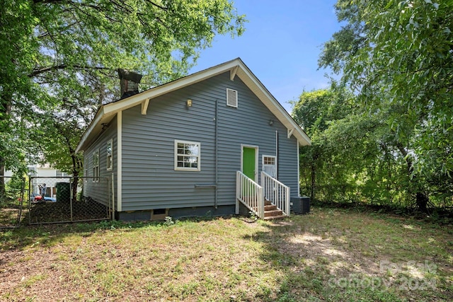 225 Flint St, Charlotte, NC 28216 - rear view of house with central air condition unit, entry steps, fence, and crawl space