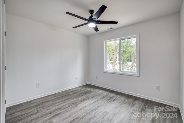 empty room featuring ceiling fan and hardwood / wood-style flooring