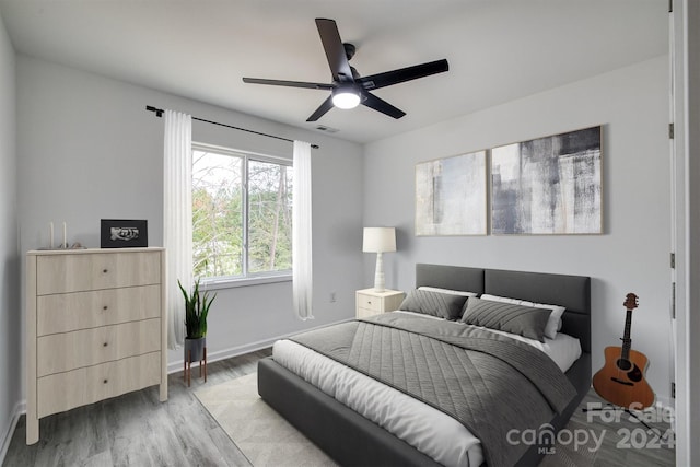 bedroom featuring ceiling fan and hardwood / wood-style flooring