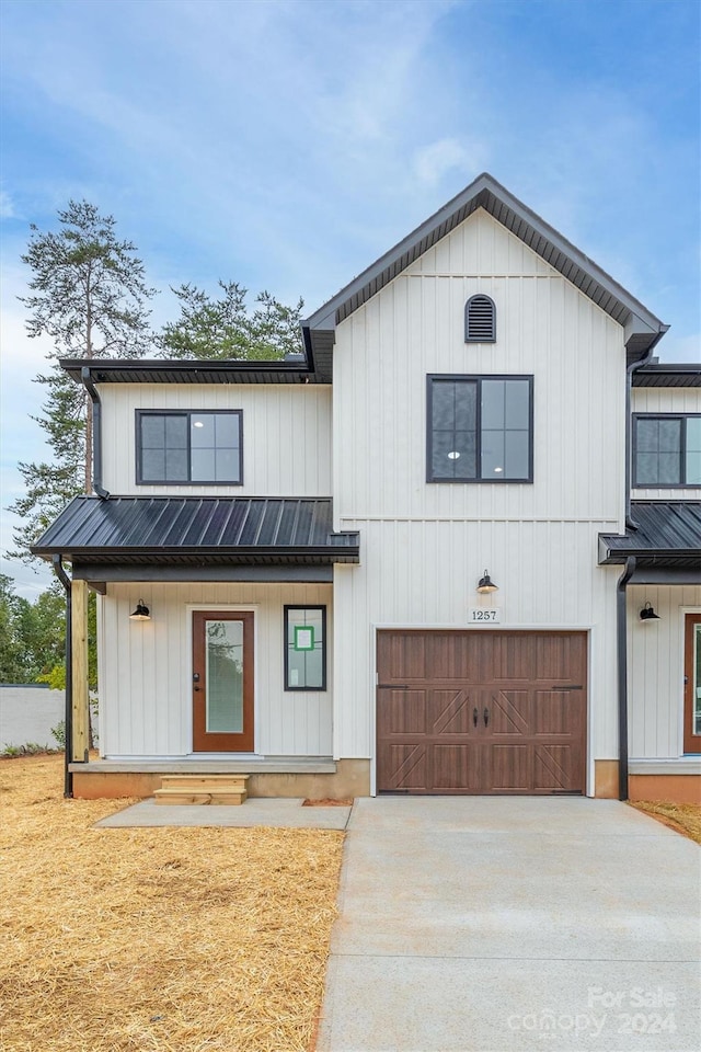 modern farmhouse with covered porch and a garage