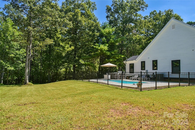 view of yard with a fenced in pool and a patio area