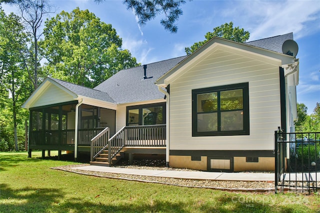 back of house featuring a sunroom and a yard