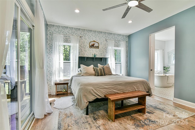 bedroom with multiple windows, hardwood / wood-style floors, and ceiling fan