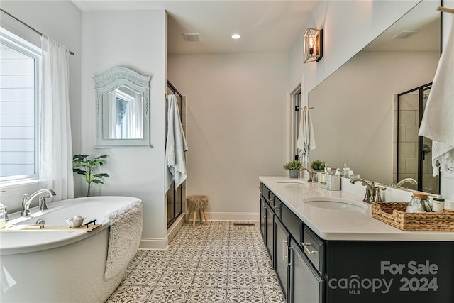 bathroom featuring vanity, tile patterned floors, and plus walk in shower