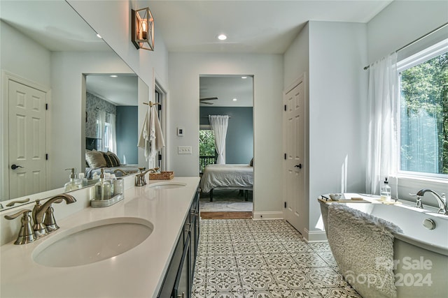 bathroom with a wealth of natural light, vanity, and tile patterned floors