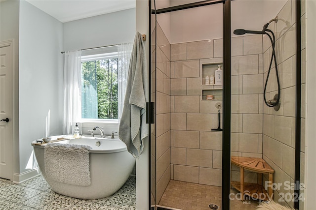 bathroom featuring independent shower and bath and tile patterned floors