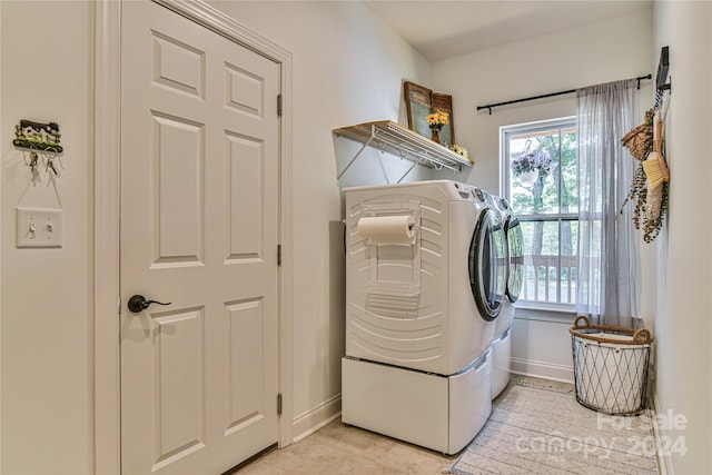 laundry area featuring washing machine and clothes dryer