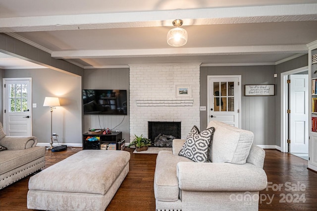 living room featuring a brick fireplace, dark hardwood / wood-style floors, beam ceiling, and ornamental molding