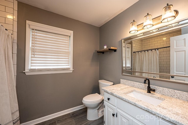 bathroom featuring hardwood / wood-style flooring, vanity, and toilet