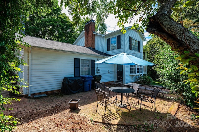 back of house with a patio