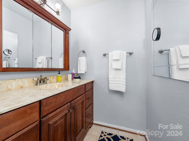 bathroom featuring tile patterned flooring and vanity