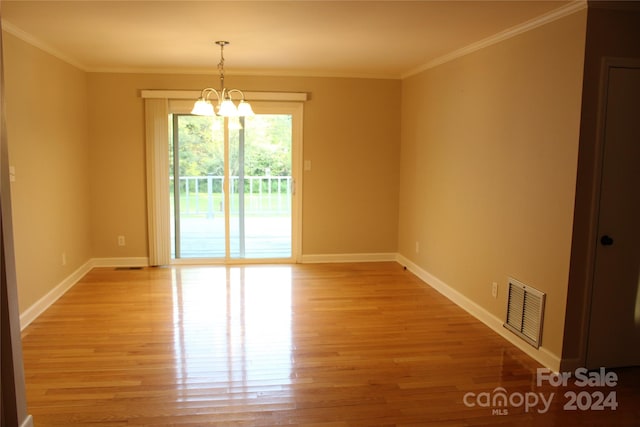 unfurnished room featuring crown molding, a chandelier, and light hardwood / wood-style floors