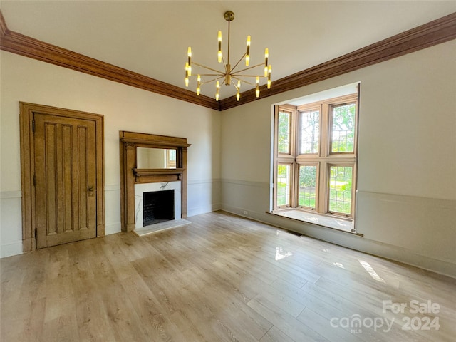 unfurnished living room with crown molding, a chandelier, and light hardwood / wood-style floors