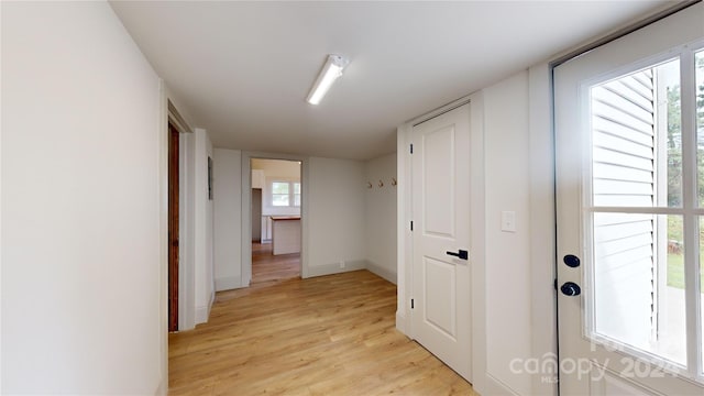 corridor with light hardwood / wood-style flooring