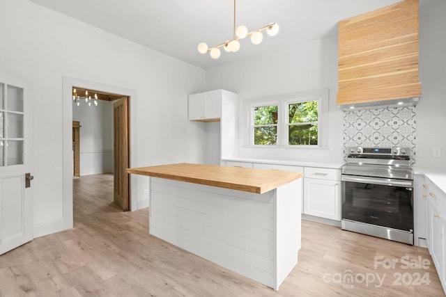 kitchen with backsplash, wood counters, light wood-type flooring, white cabinetry, and electric stove