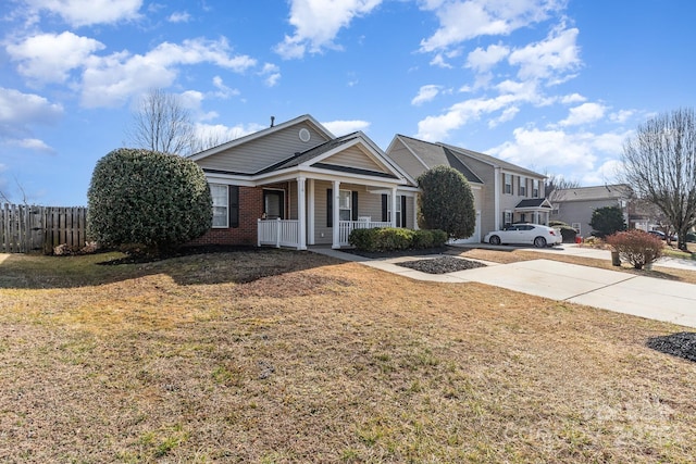 view of front of home with a front yard and covered porch