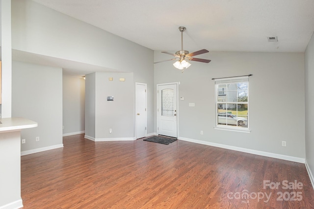 unfurnished living room with vaulted ceiling, dark hardwood / wood-style floors, and ceiling fan