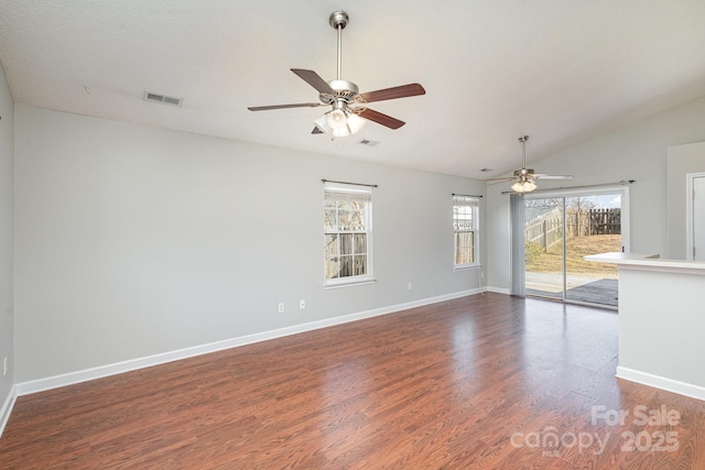 unfurnished room with vaulted ceiling, dark wood-type flooring, and ceiling fan