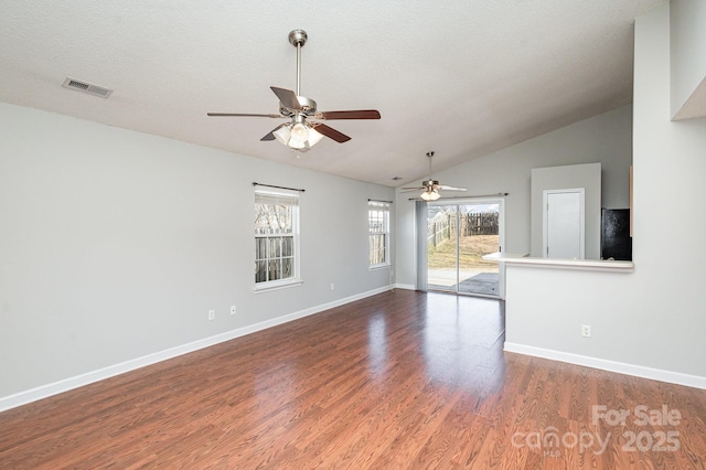 empty room featuring vaulted ceiling, ceiling fan, a textured ceiling, and dark hardwood / wood-style flooring