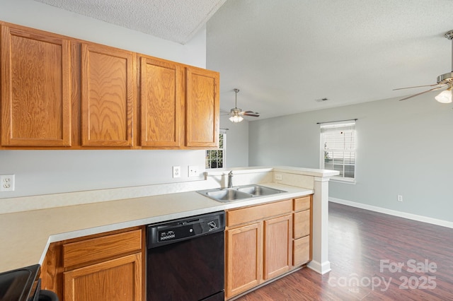 kitchen featuring black dishwasher, sink, ceiling fan, kitchen peninsula, and a textured ceiling