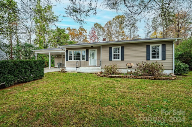 ranch-style house featuring a front lawn and a carport