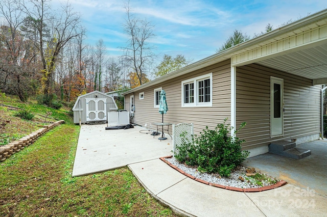 view of side of home featuring a patio area and a shed