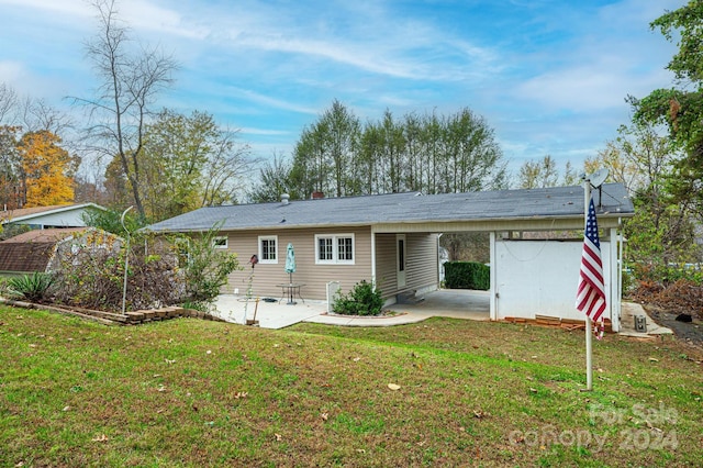 back of house featuring a yard and a patio