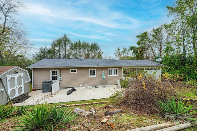 back of house featuring a patio area and a storage shed