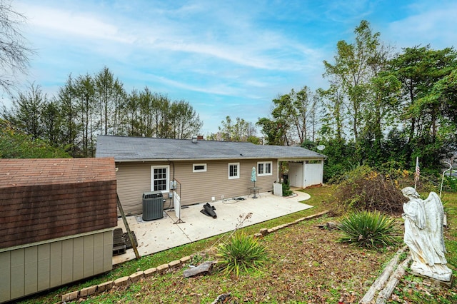 rear view of property featuring central AC, a storage shed, and a patio area