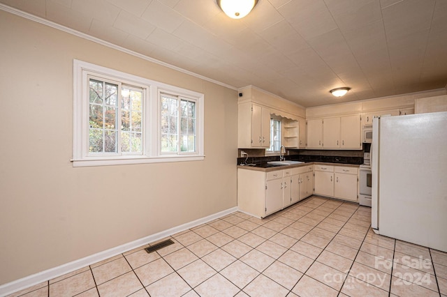 kitchen with white appliances, white cabinets, sink, light tile patterned floors, and ornamental molding