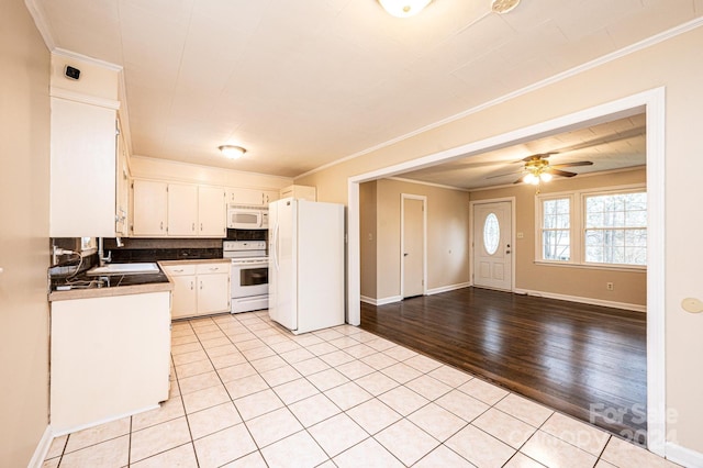 kitchen featuring light wood-type flooring, tasteful backsplash, ornamental molding, white appliances, and white cabinetry