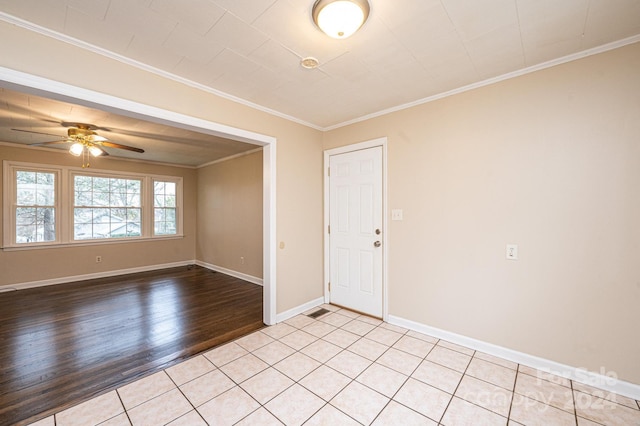 empty room with light wood-type flooring, ceiling fan, and crown molding