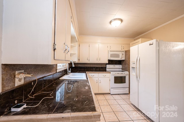 kitchen with white cabinets, light tile patterned flooring, white appliances, and sink