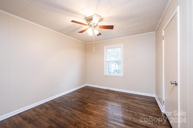 empty room featuring crown molding, dark hardwood / wood-style flooring, and ceiling fan