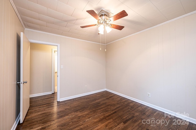 spare room with ceiling fan, dark hardwood / wood-style flooring, and crown molding